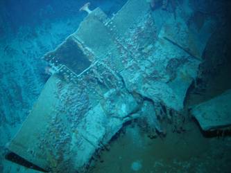 Large pieces of twisted steel plate on seabed. Note rivets